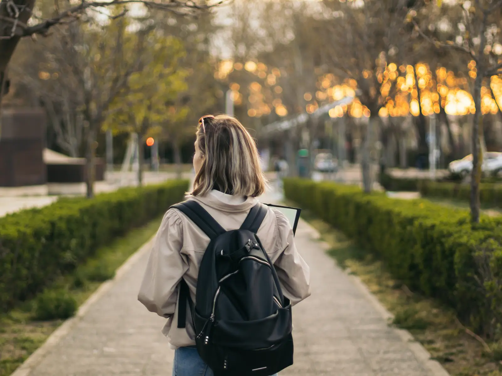 Image of female college student walking on campus.