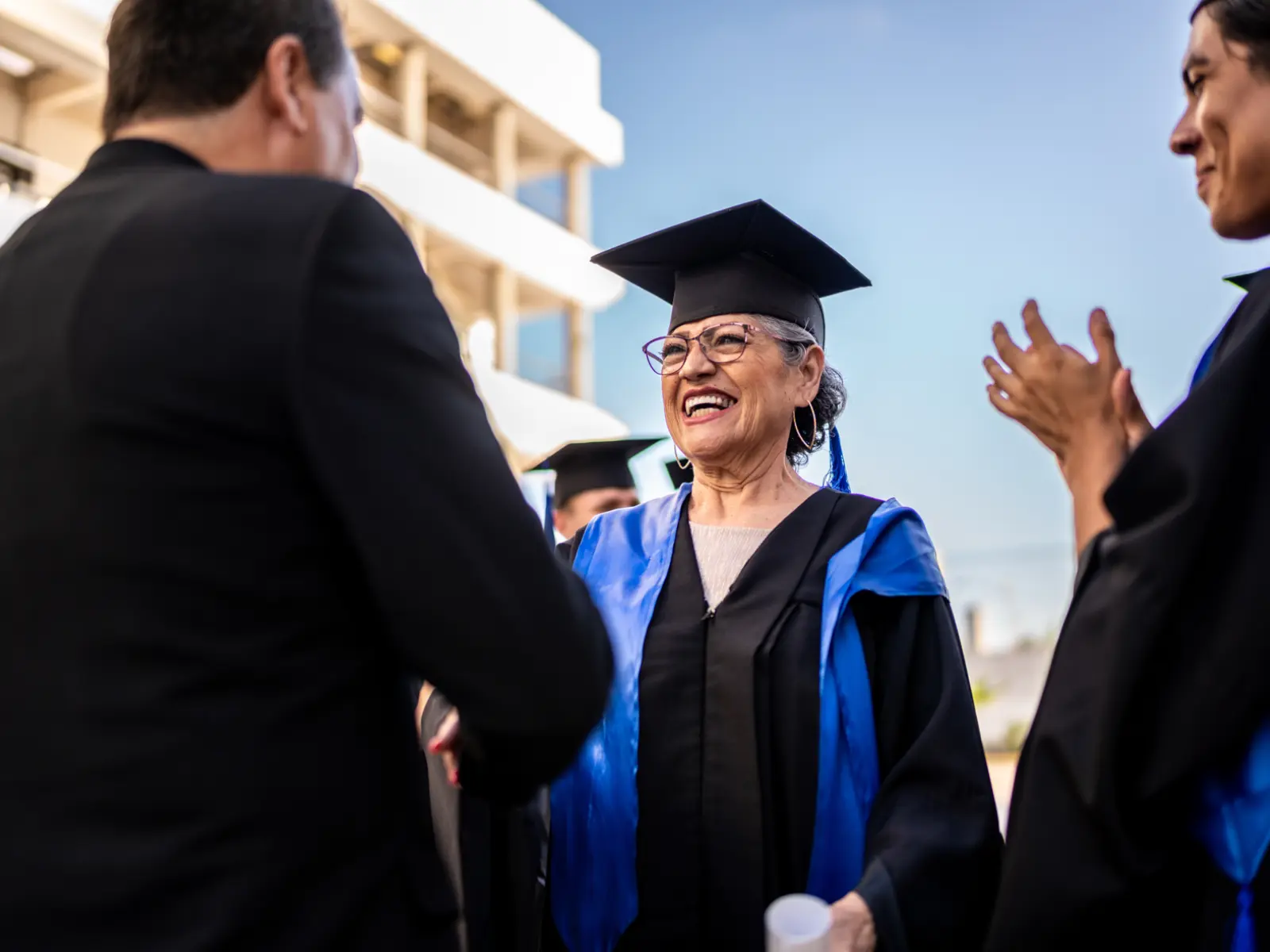 Female college student receiving college diploma.