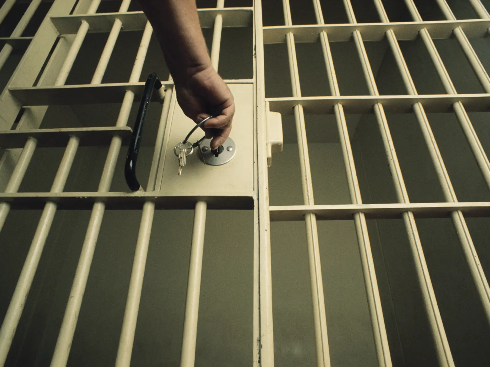 Image of jail cell being unlocked.