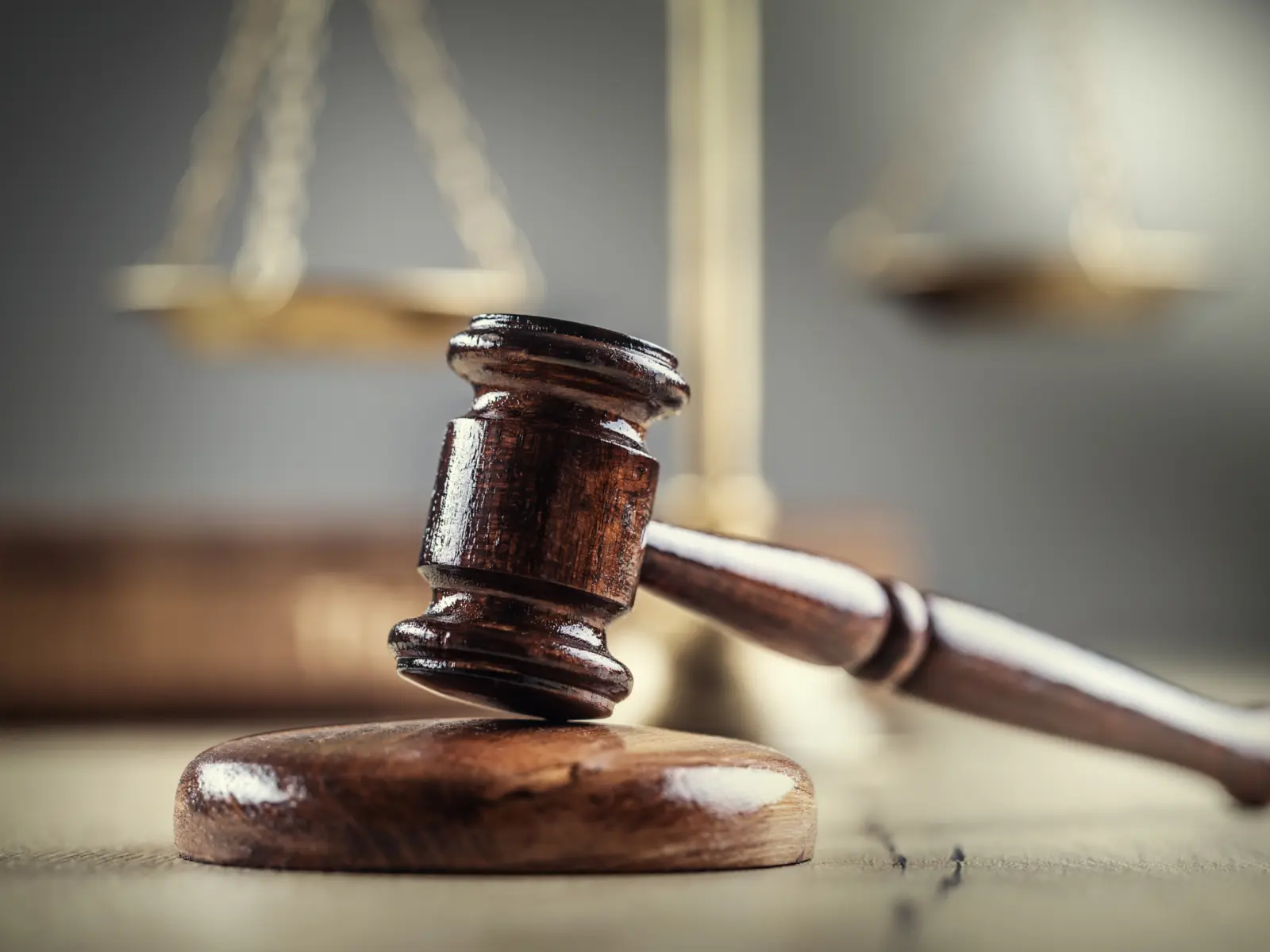 Image of gavel and scales in the background.