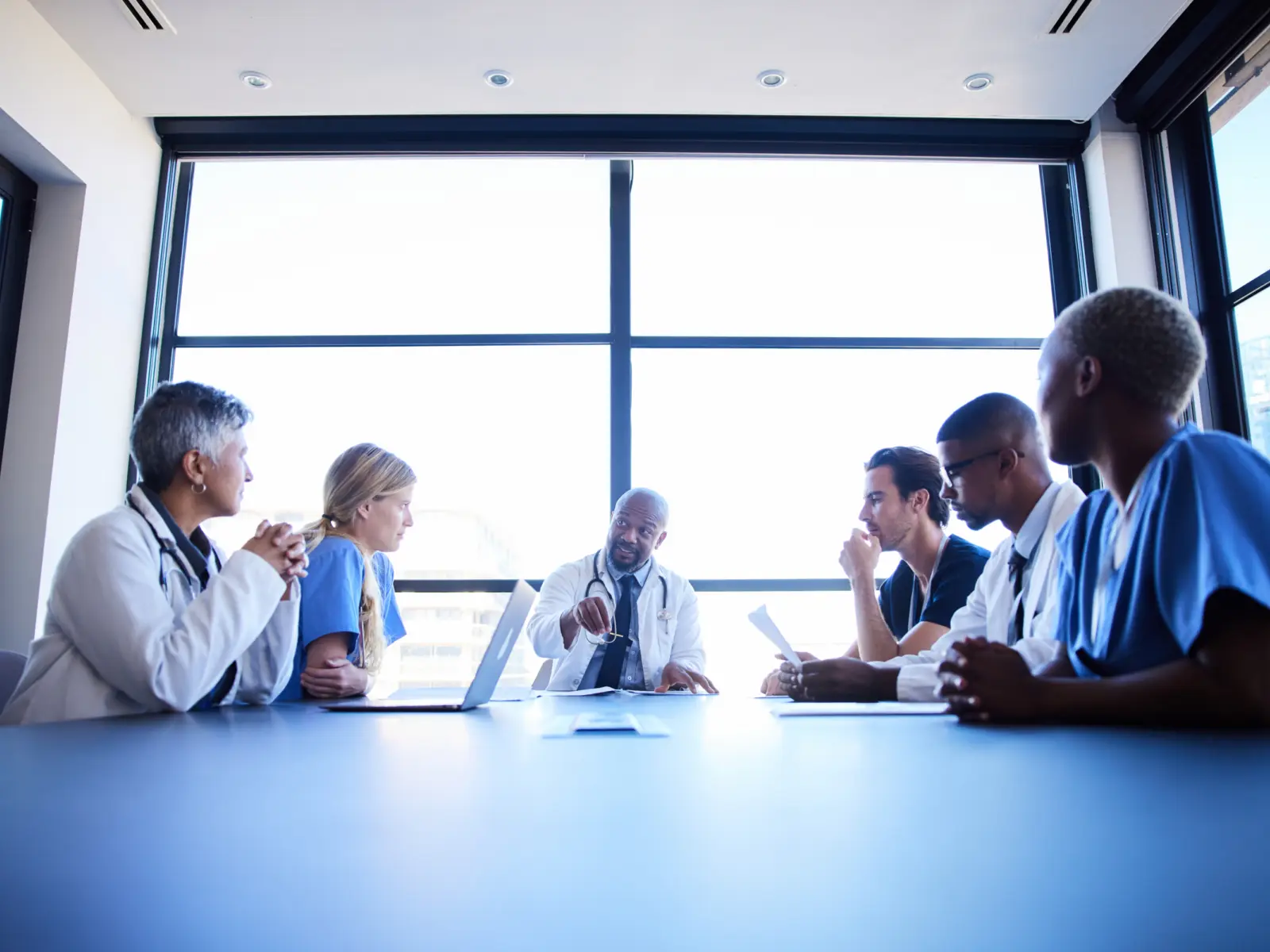 Image of health professionals speaking at a table.