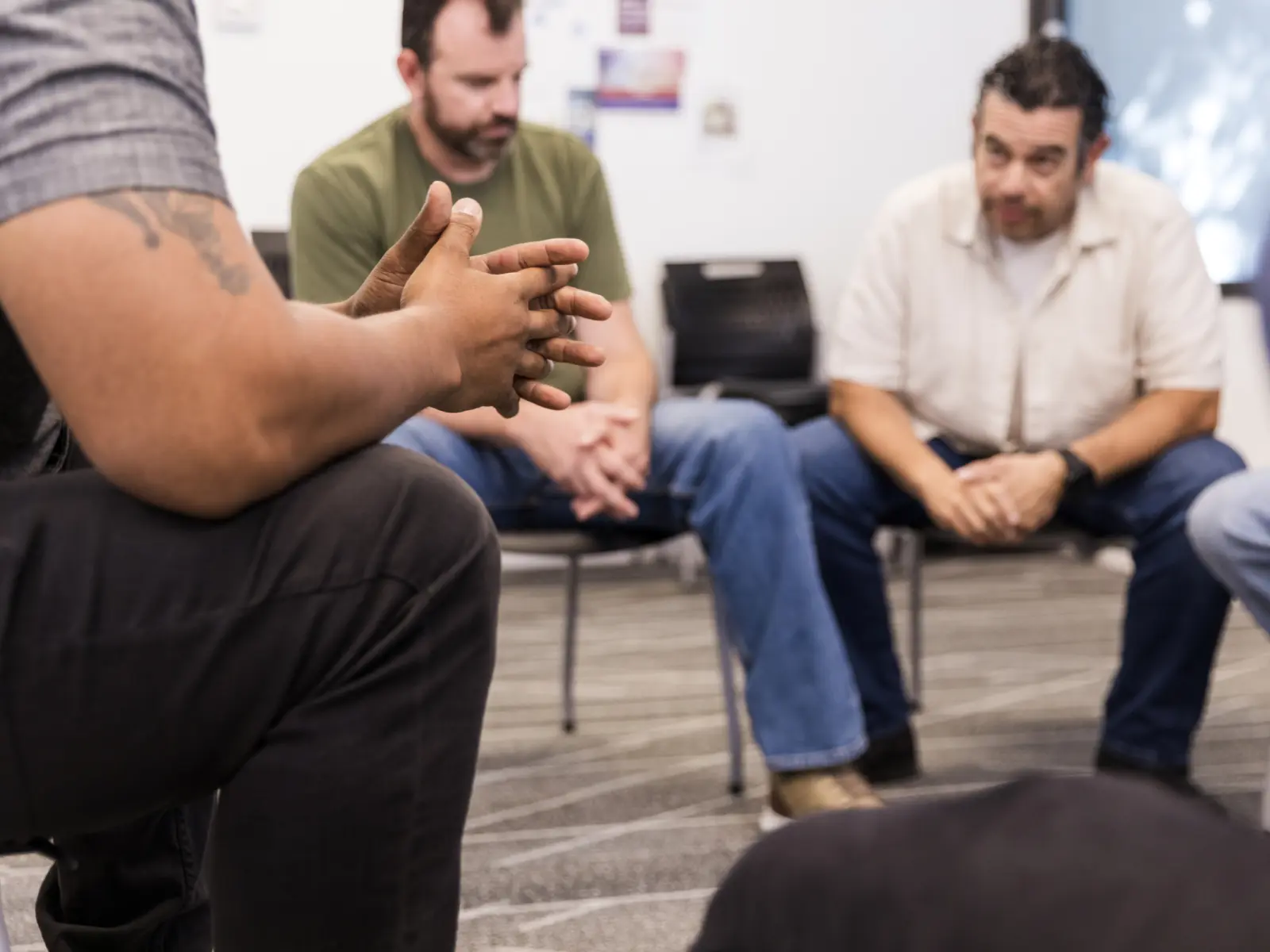 Image of group session with males talking.