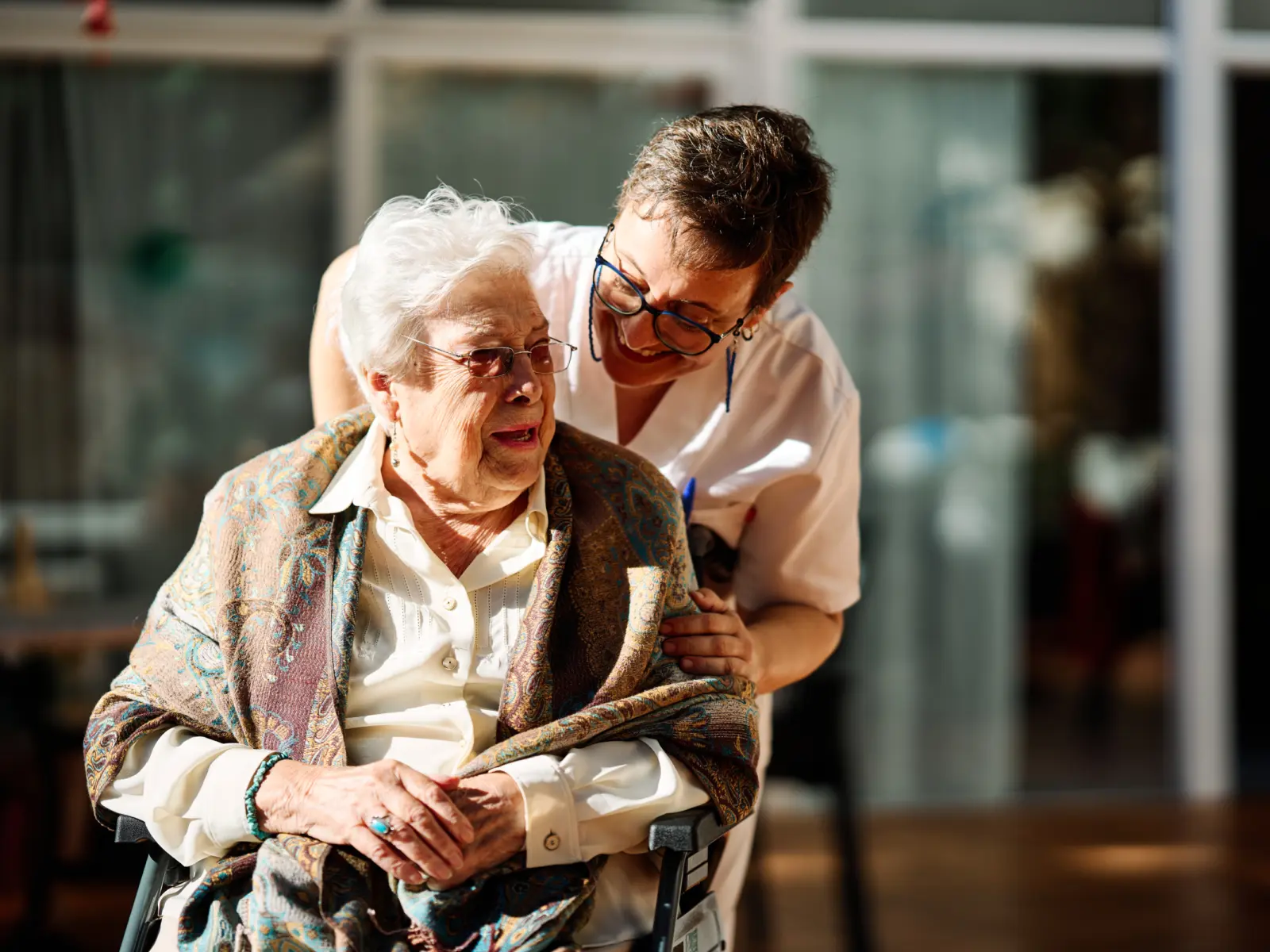 Image of female provider caring for female elderly patient.
