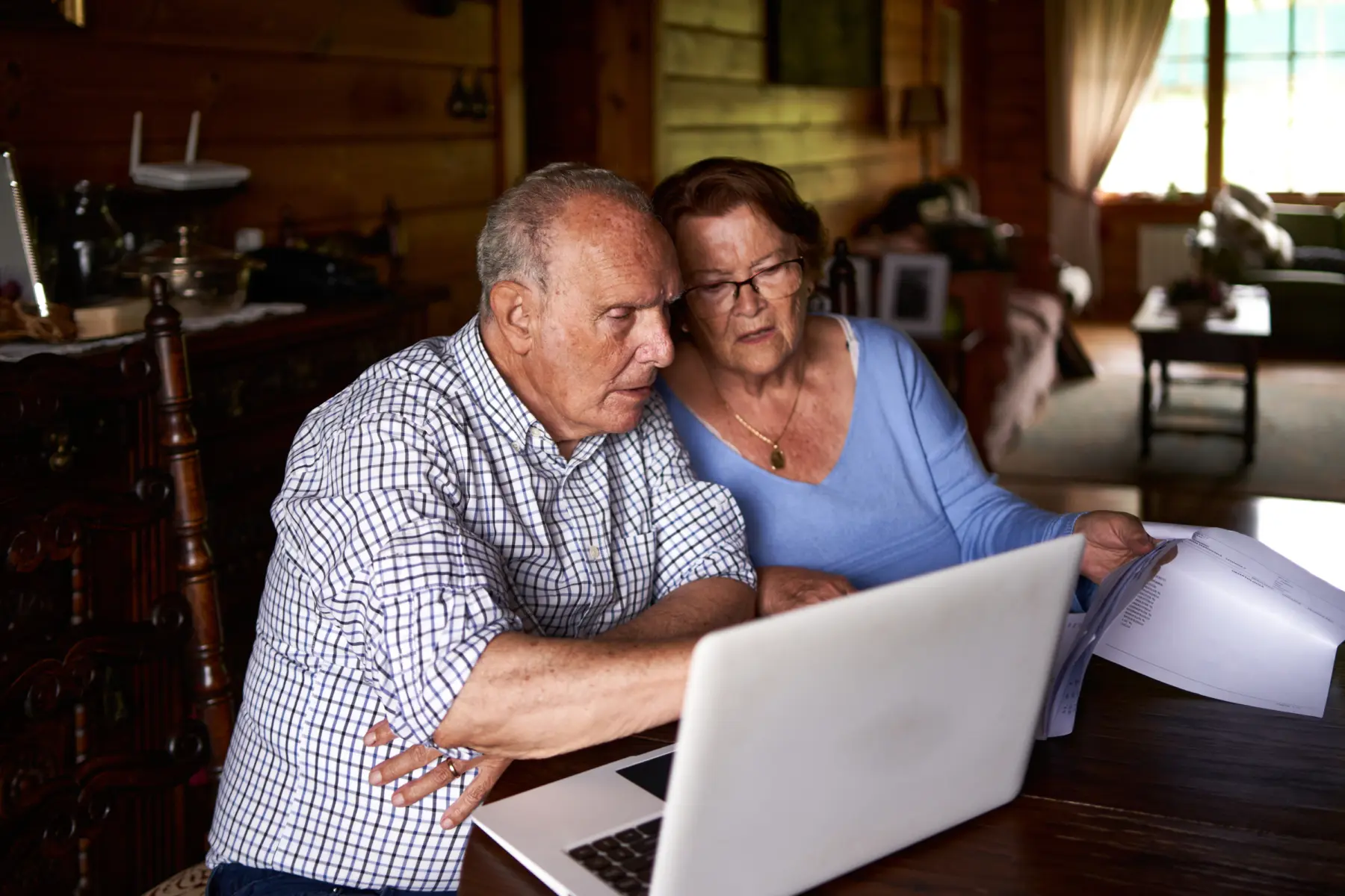 A man and women in front of laptop reviewing bills.