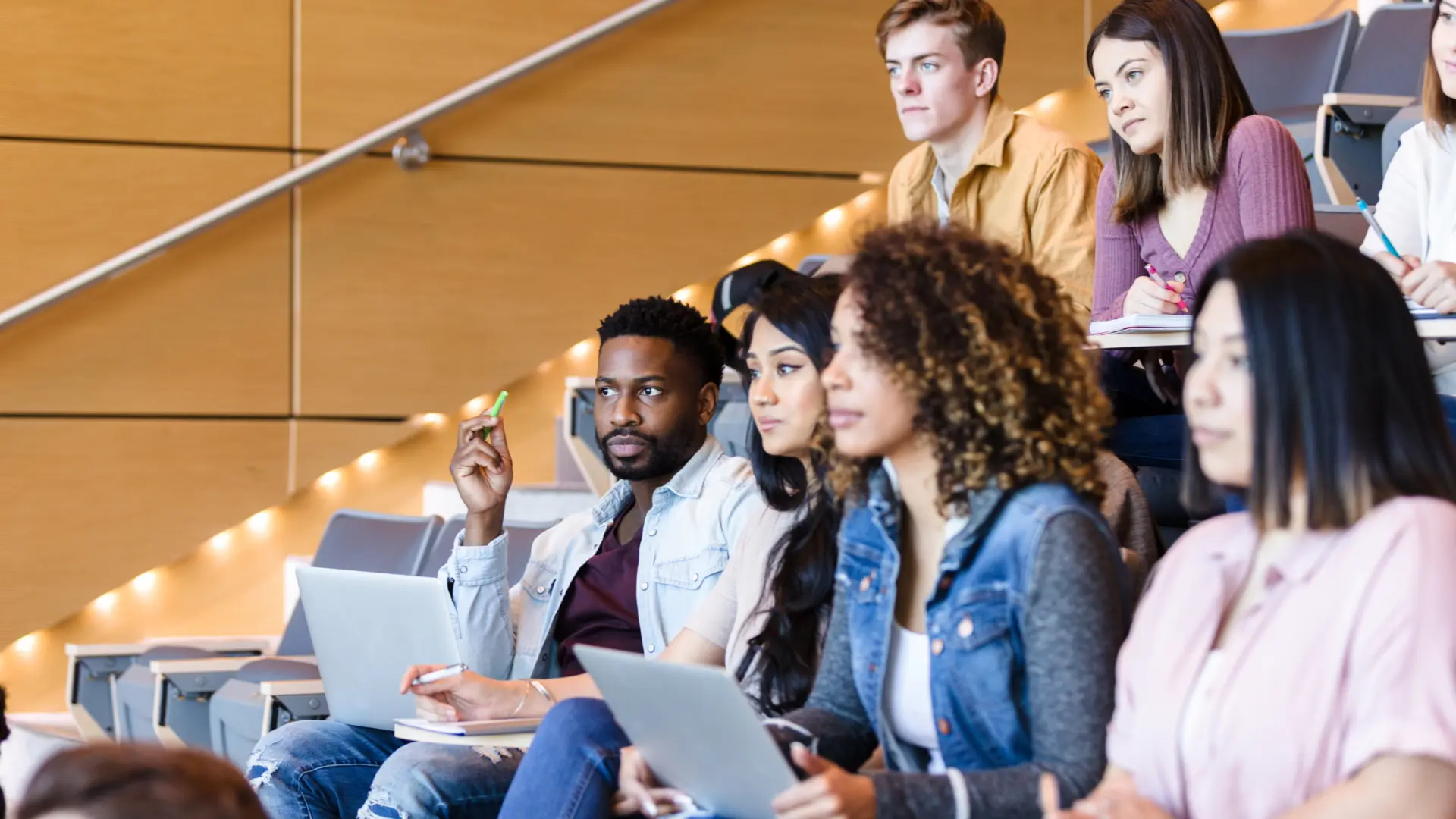 Image of diverse college classroom with students in session.