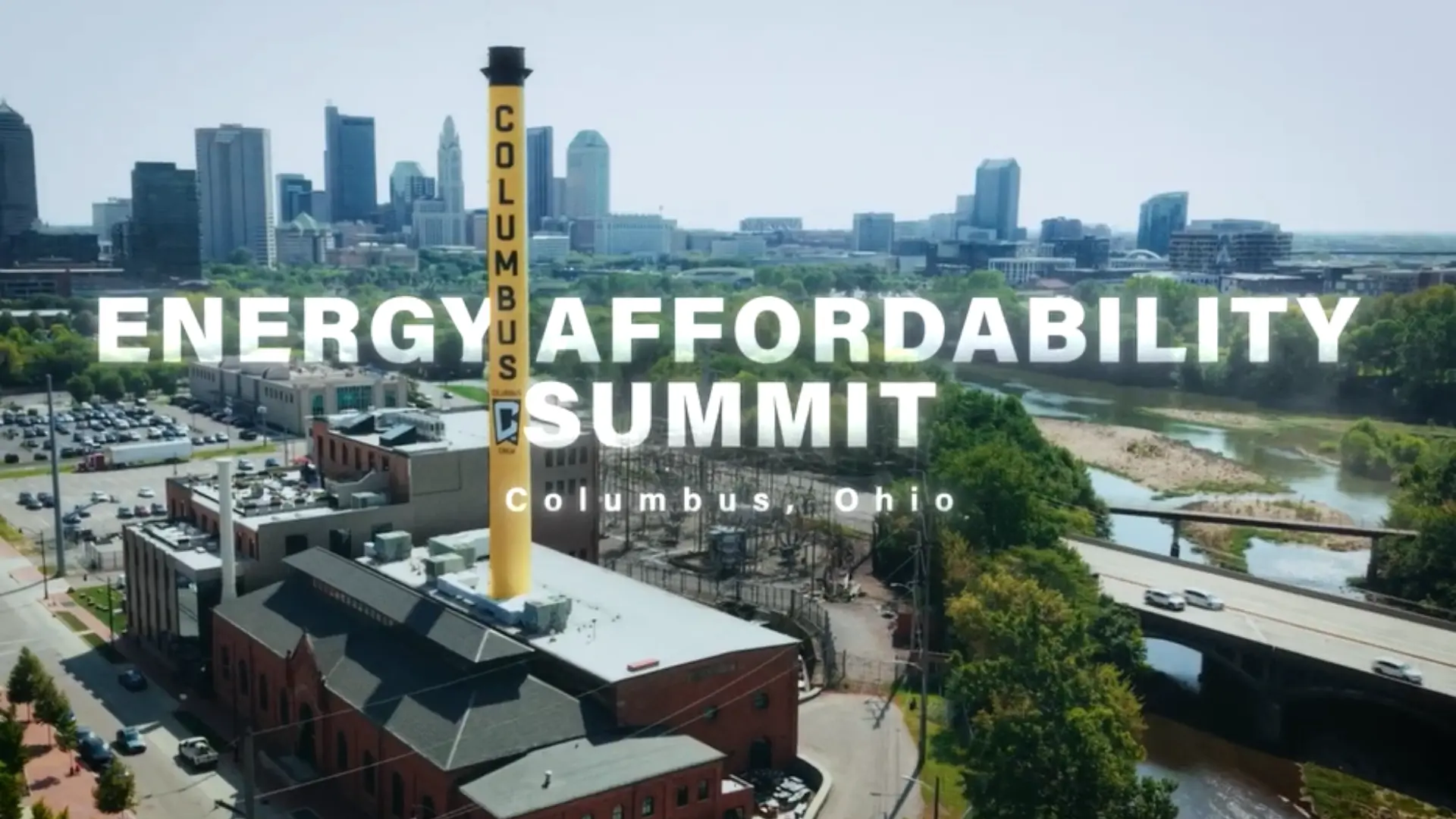 Columbus, Ohio skyline with a yellow Columbus chimney beside a river and bridge, overlaid with Energy Affordability Summit text.