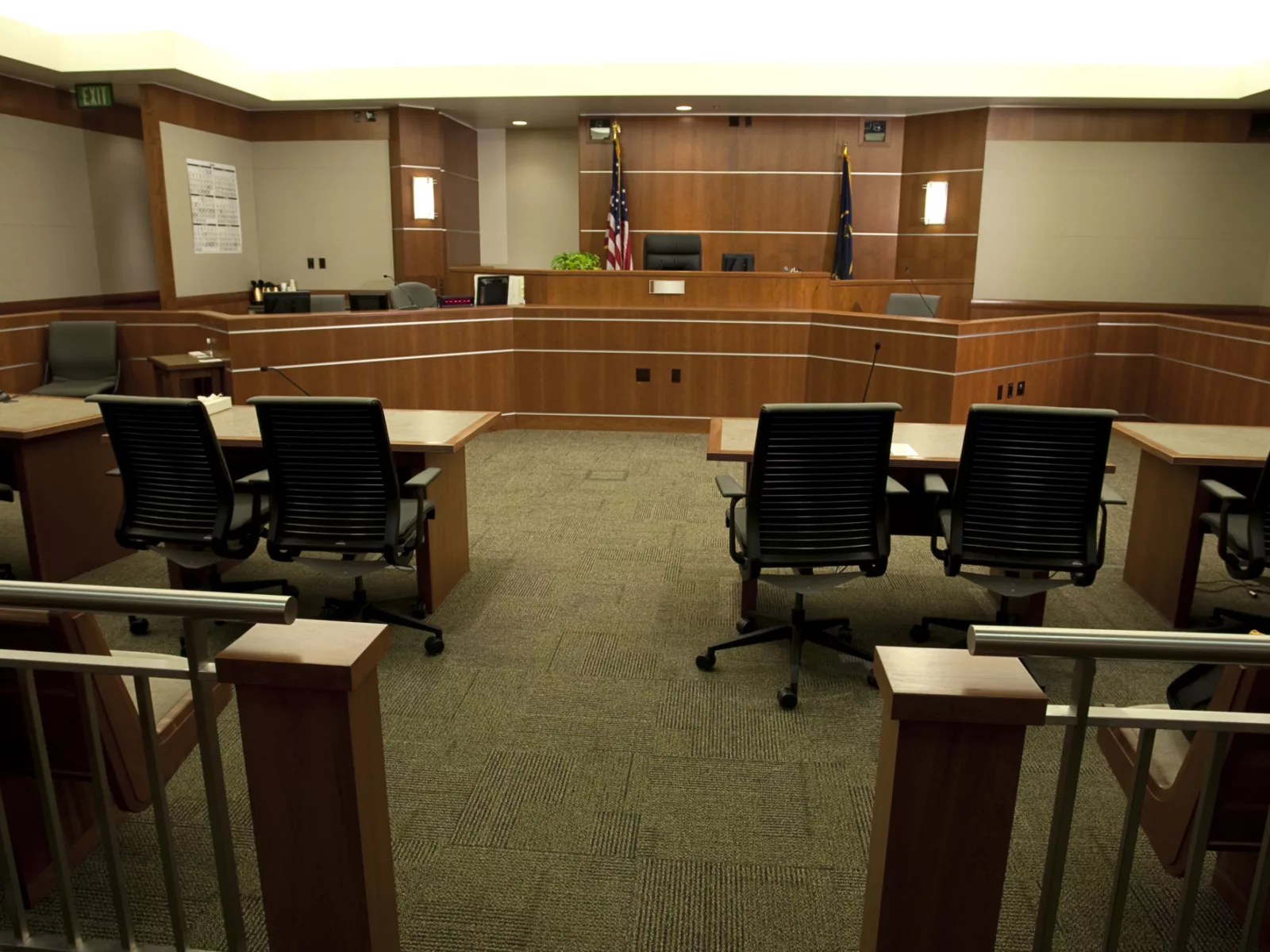 Wide angle view of modern courtroom from gallery's point of view.