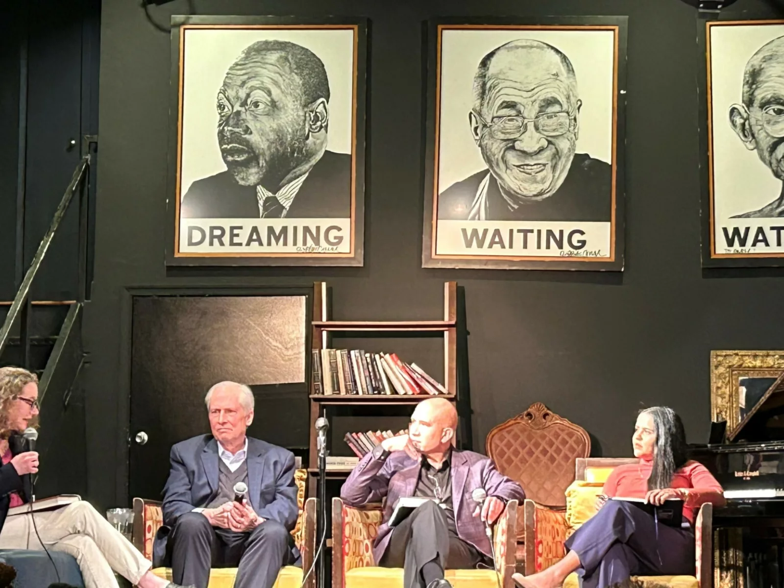 Panel of four people on stage discussing the new book release of Jeremy Travis.