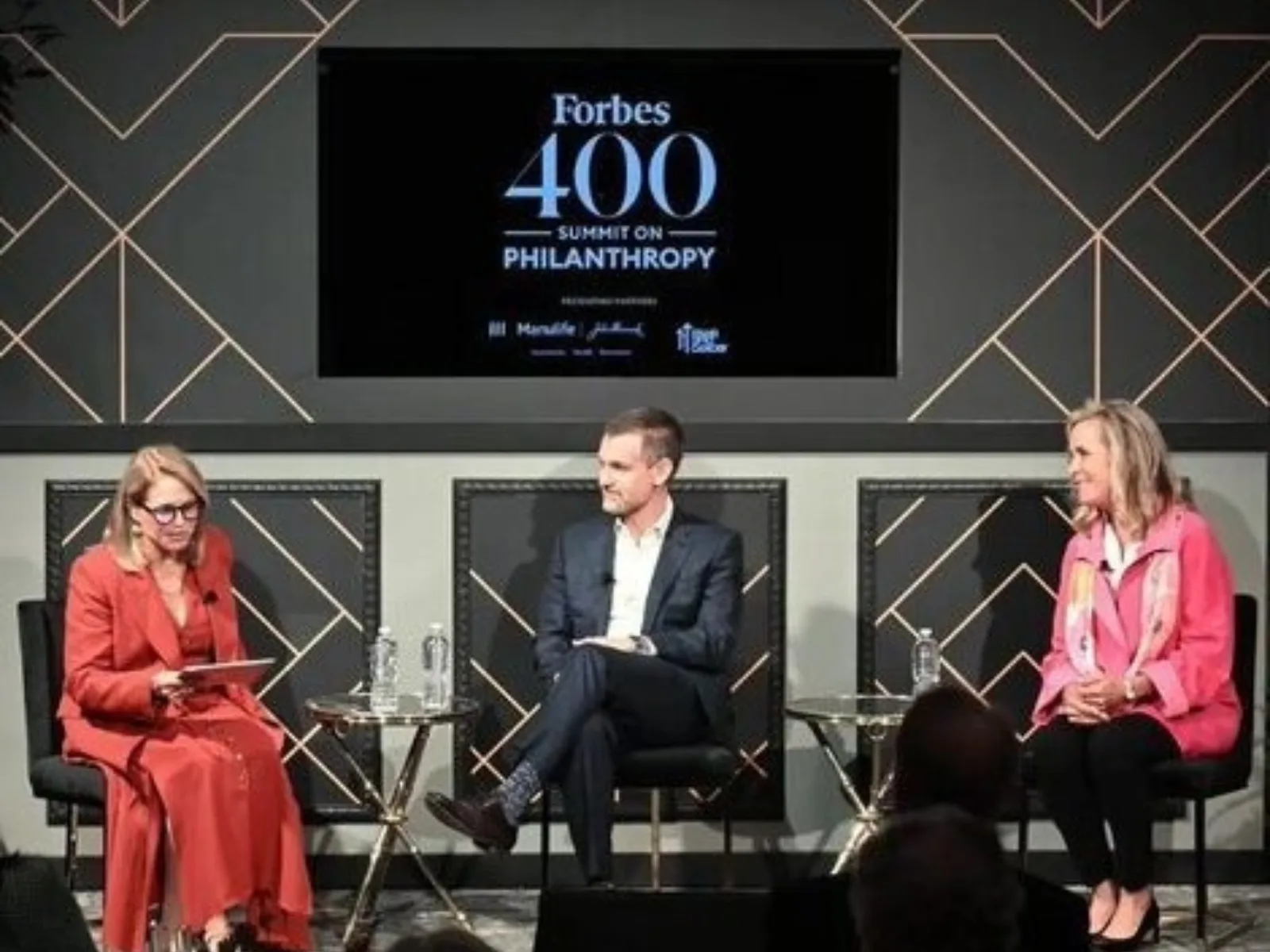 Image of speakers sitting on stage talking.