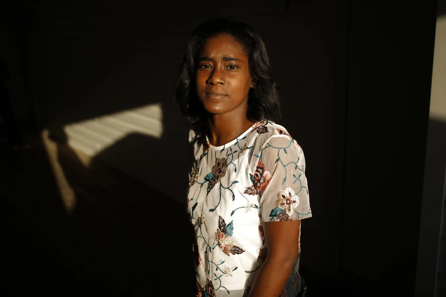 LaQuayia Goldring stands in front of a wall looking at the camera.