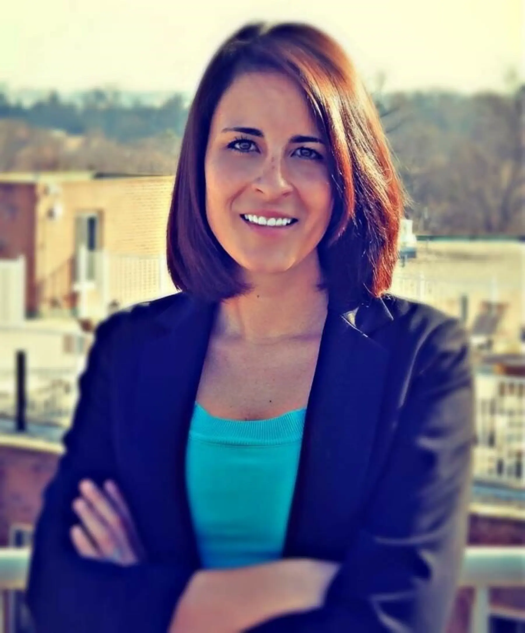 Kate Keith standing in front of city landscape.