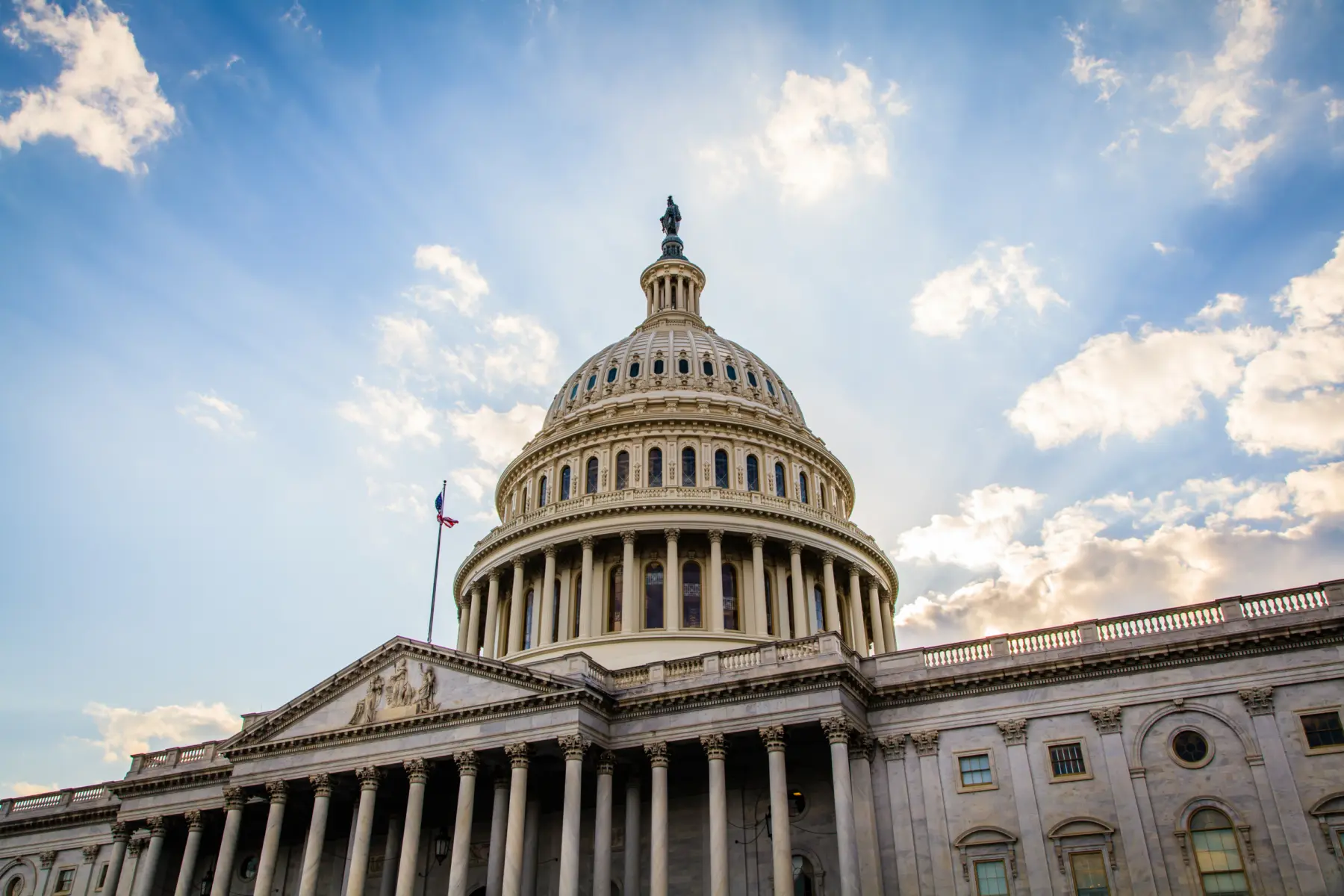 Angled image of u.s. congress building with blue sky in background.