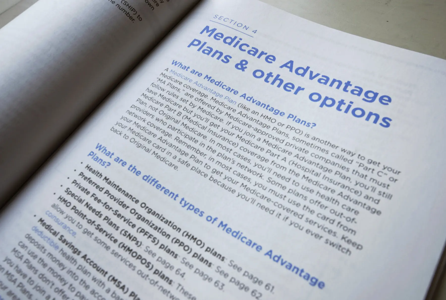 A Medicare Advantage plan book is open to a page with details about the programs.