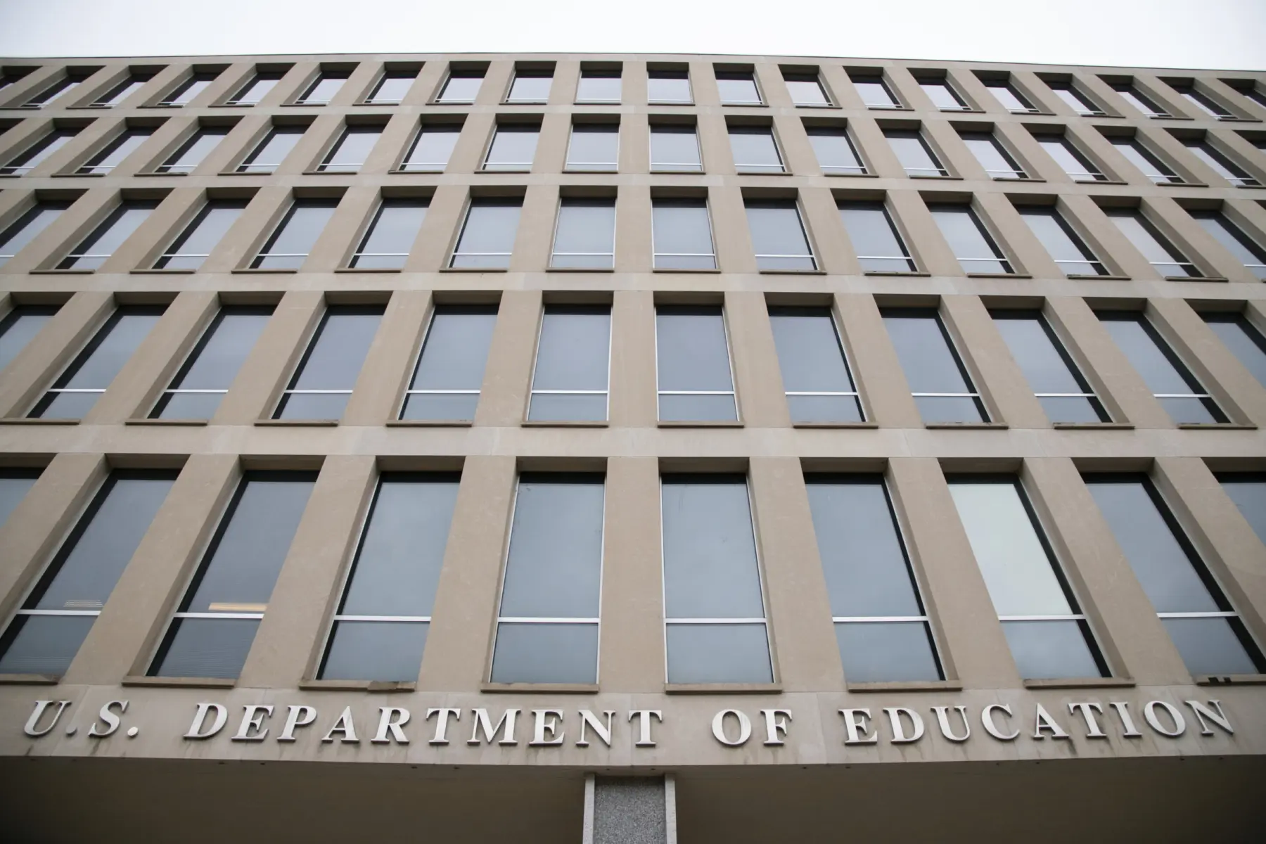 The facade of the U.S. Department of Education building features a modern design with multiple windows and prominent lettering.